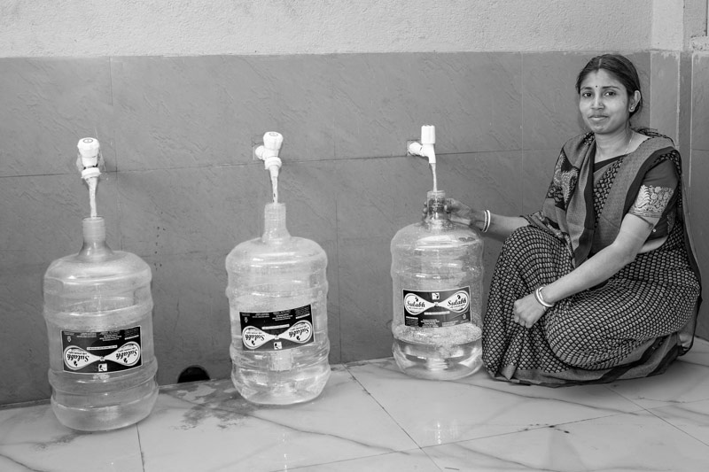 Treated pure drinking water emerging from the UV filter being filled in 20 liters plastic jars at the Sulabh Safe Drinking Water plant in Panchberia village, Paschim Medinipur district, West Bengal